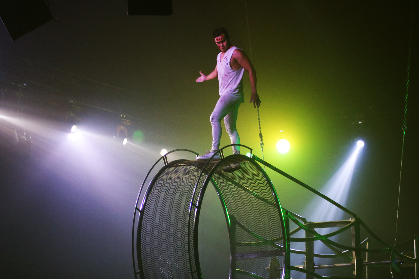 An acrobat leads the final performance of the cirque. He climbed all throughout the contraption, running alongside the outer edge and jumping rope. 