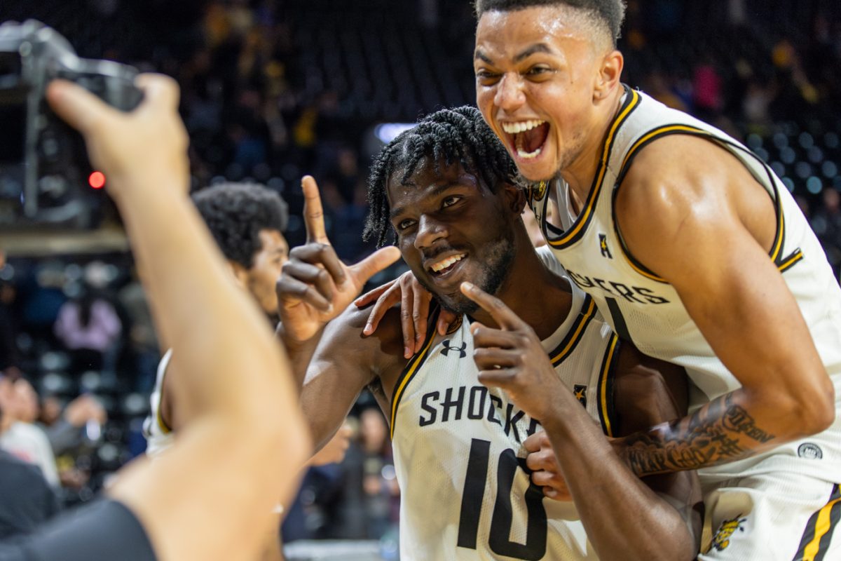 Dalen+Ridgnal+and+Xavier+Bell+pose+for+a+photo+after+their+win+against+the+Richmond+Spiders+on+Nov.+29.+The+Shockers+won+80-68+on+Koch+Arenas+20th+anniversary.