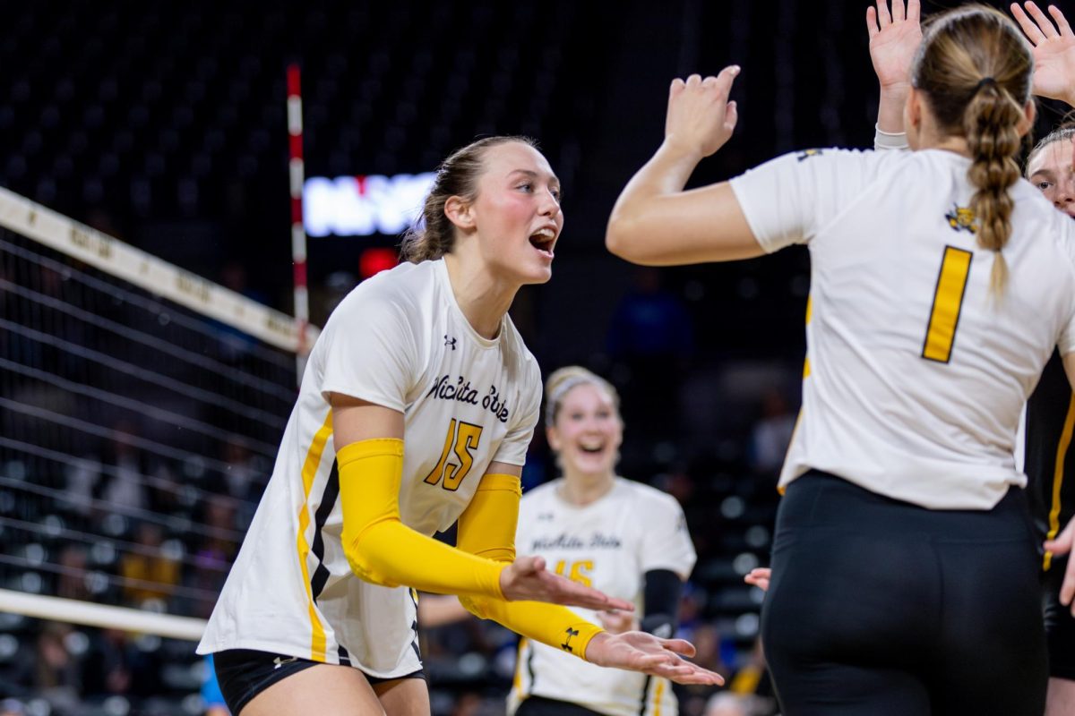Morgan Stout turns to her teammates to celebrate a point in the third set of the Great 8 match. Stout scored 18 points for the Shockers, including 14 kills.