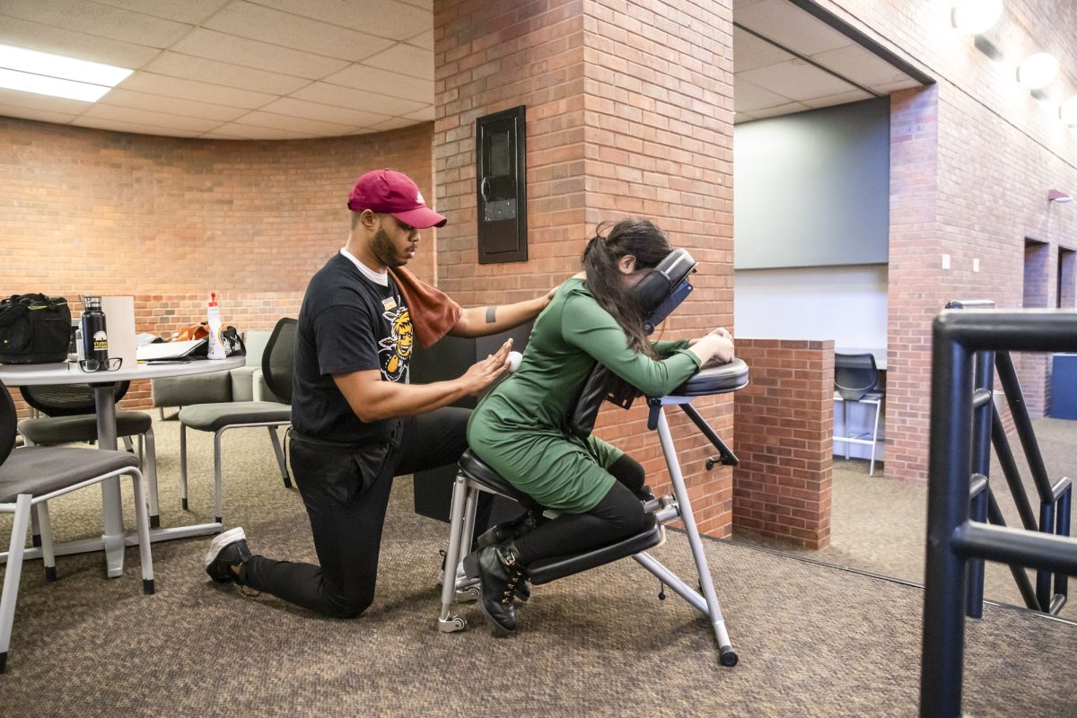 Freshman Caitlyn Soto-De La Cerda receives a chair massage at the Heskett Center on Dec. 5.