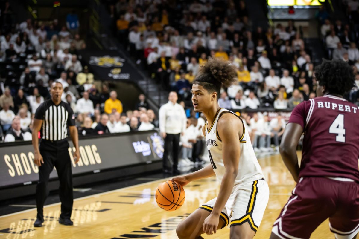 Junior forward Kenny Pohto prepares to take a shot during the Dec. 16 game against Southern Illinois inside Charles Koch Arena.
