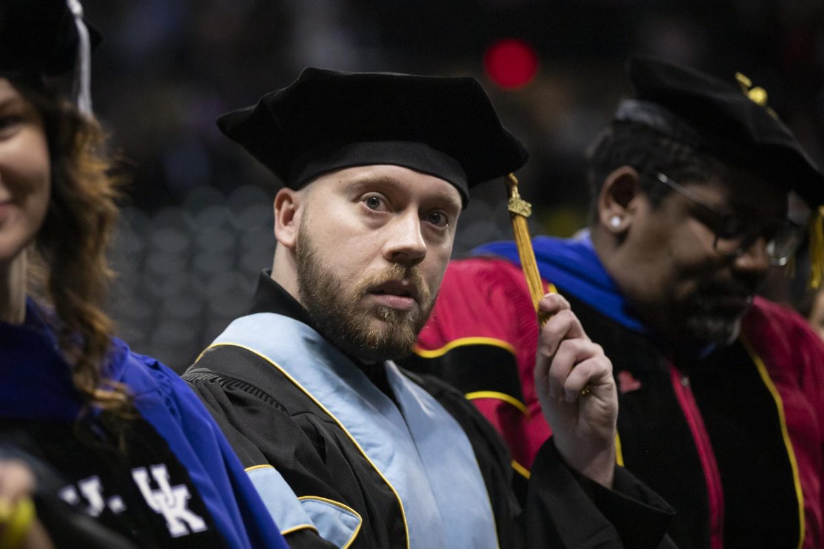 Brandon Dorion looks off into the crowd of Charles Koch Arena during the Fall 2023 Commencement ceremony. Dorion graduated with a doctorate of education.