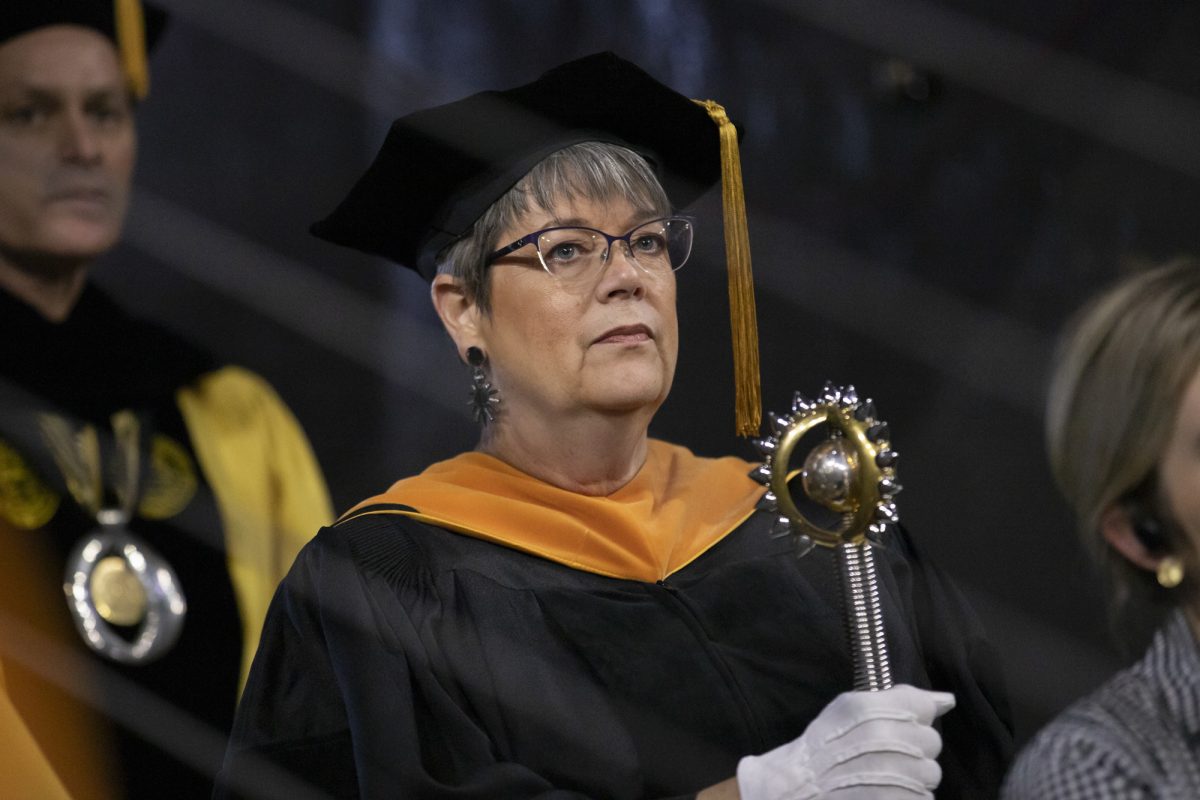 Jolynn Dowling, an associate educator in the College of Health Professions, holds The University Mace before the start of the Fall 2023 Commencement ceremony. The University Mace is a symbol of authority and power.