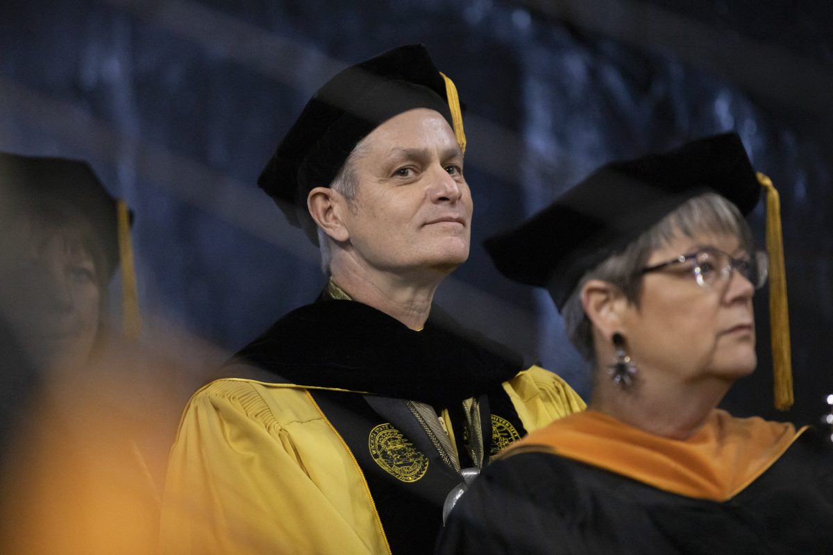 Wichita State University President Richard Muma stands in Charles Koch Arena before the start of the Fall 2023 Commencement ceremony on Dec. 17.