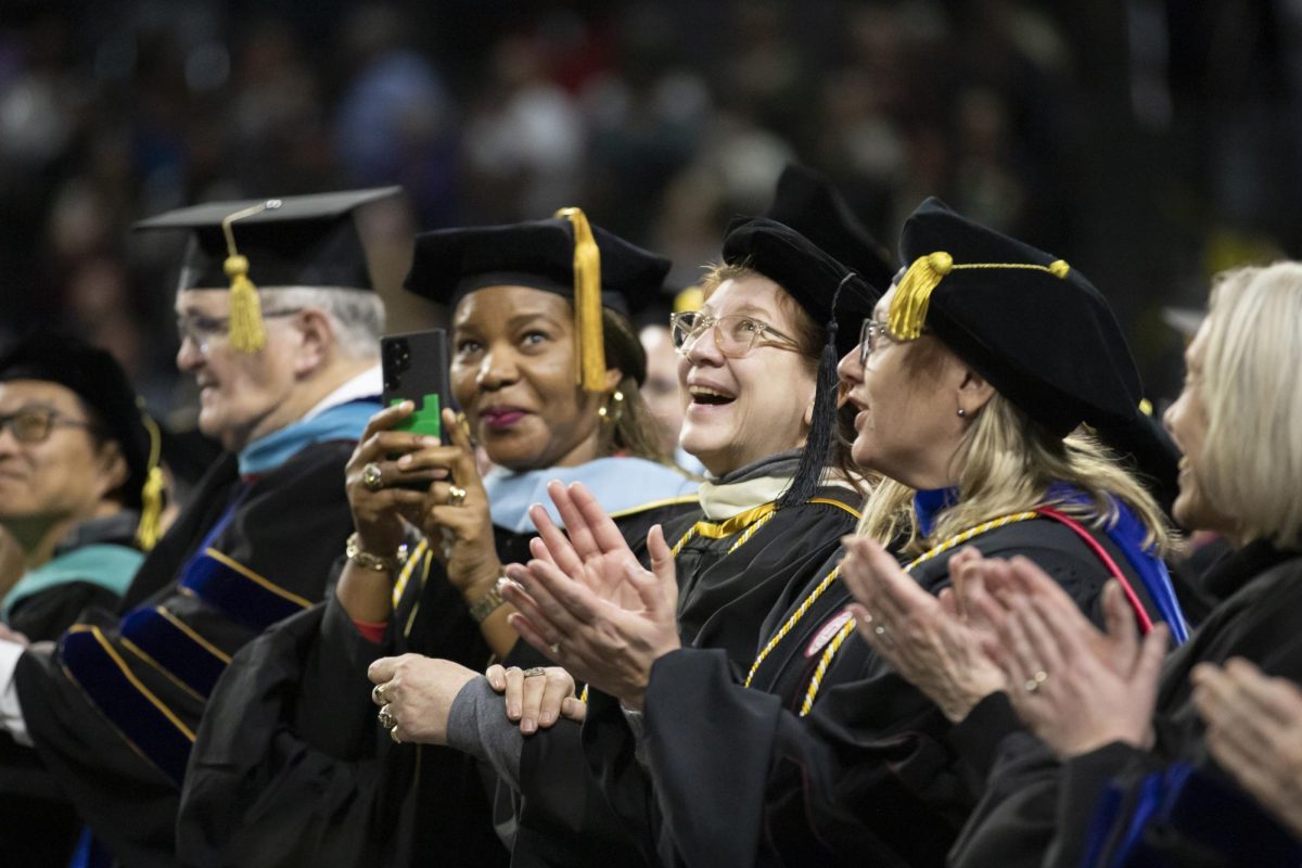 Staff, faculty and graduates watch as confetti falls in Charles Koch Arena, following the conclusion of the 126th Commencement ceremony on Dec. 17.
