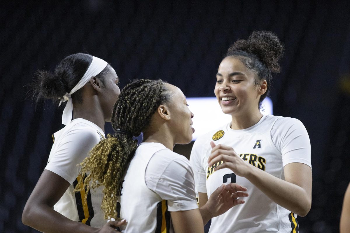 Senior forward Sierra Morrow smiles at her teammates after a successful play by Wichita State on Dec. 30.