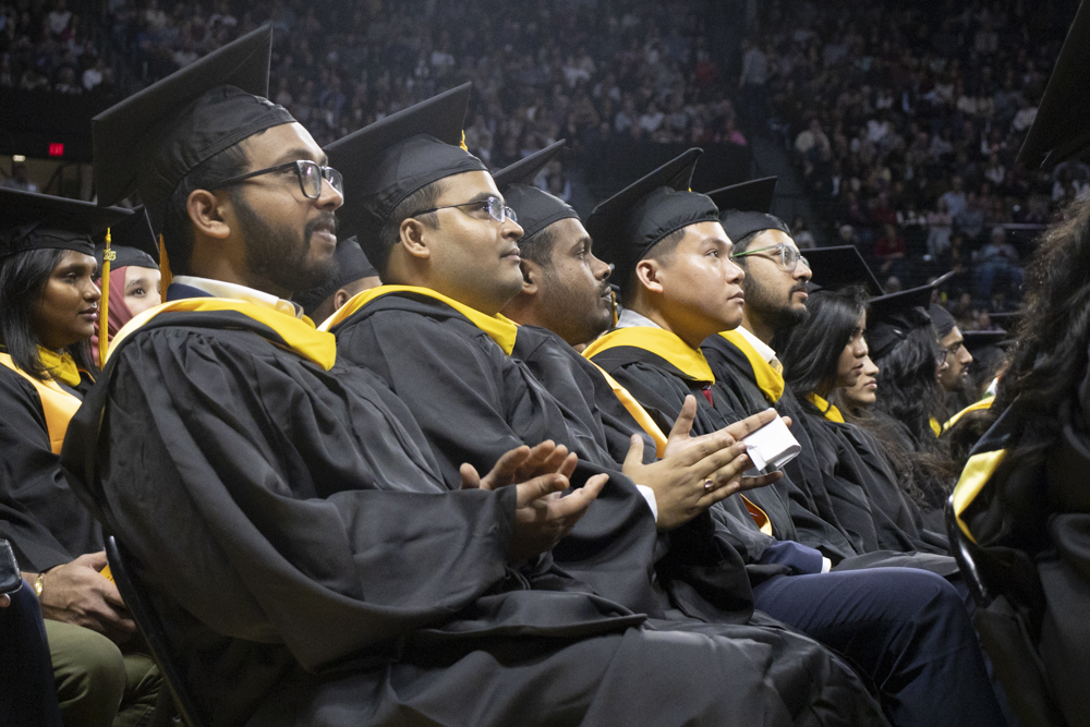 Wichita State graduates clap during the fall 2023 commencement ceremony on Dec. 17.