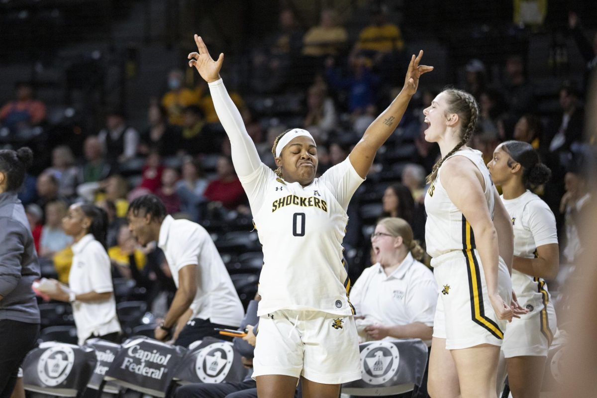 After defeating Tulane University, senior guard Aniya Bell celebrates on the sidelines. The Shockers defeated the Green Wave by three points, 63-60.