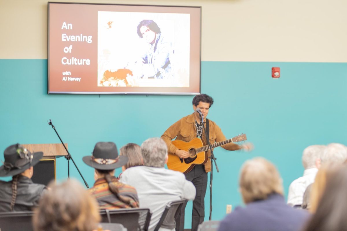 Wichita-raised AJ Harvey performs for a crowd at the Mid-America All-Indian Museum. The event was a fundraiser for The Stumblingbear Regalia Cupboard, which aims to loan traditional attire to Native American youth.