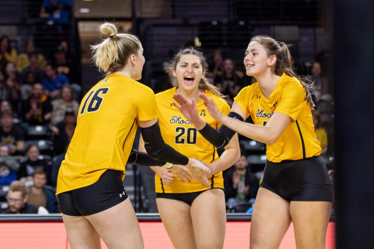 The+Shockers+celebrate+a+point+made+in+the+second+set+against+Montana+State+on+Dec.+9.+