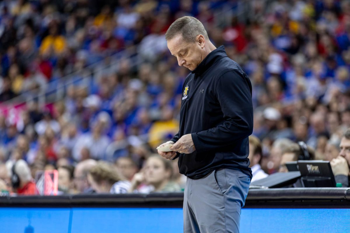 Paul Mills looks at his notes as the Shockers suffer a significant point defecit agaisnt KU in the second half. The Shockers fell to 2nd ranked team KU in their last non-conference game on Dec. 30.