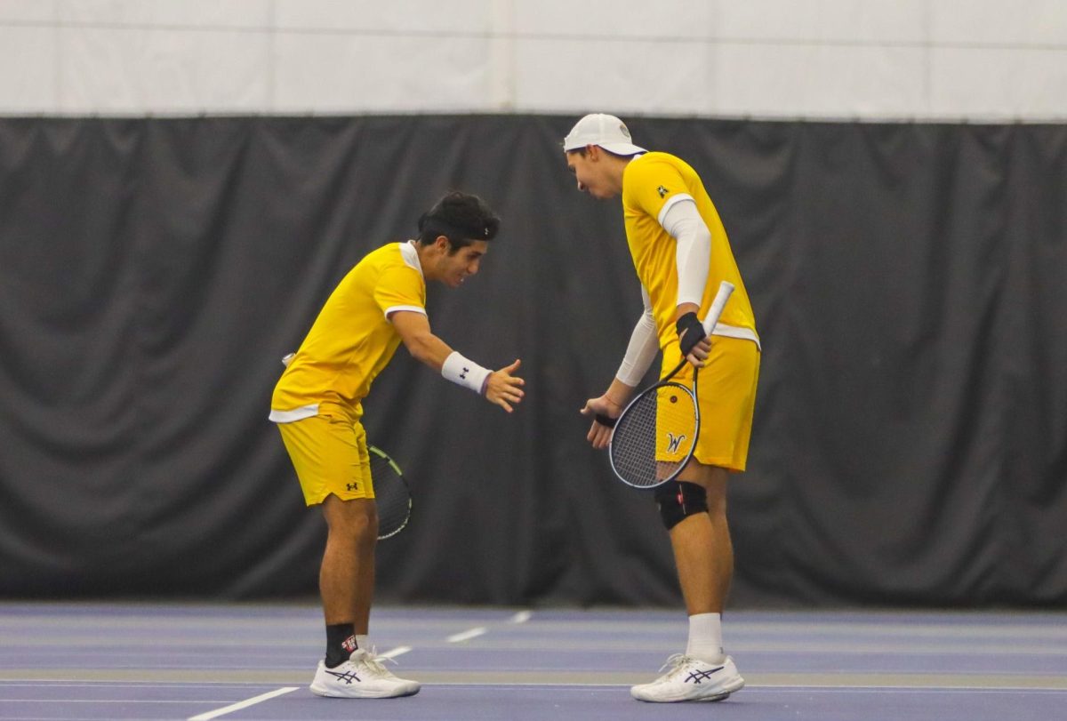 Sophomore+Alejandro+Jacome+and+freshman+Vanja+Hodzic+get+together+during+their+doubles+match+against+Omaha+on+Jan.+26.
