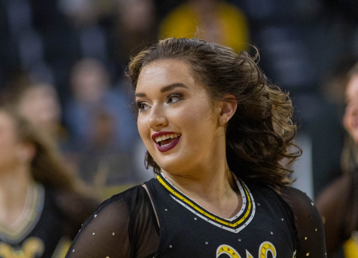 Claire Gray, a dancer with the Wichita State Spirit Squad, cheers with the squad during the game against Southern Methodist University on Jan. 28.