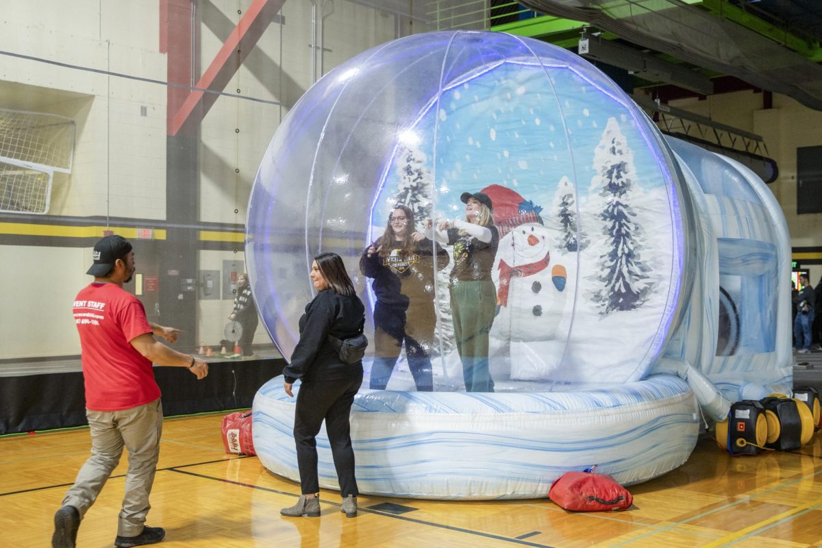 Wichita State students and community members pose in the snow globe at the Winter Welcome on Jan. 19.