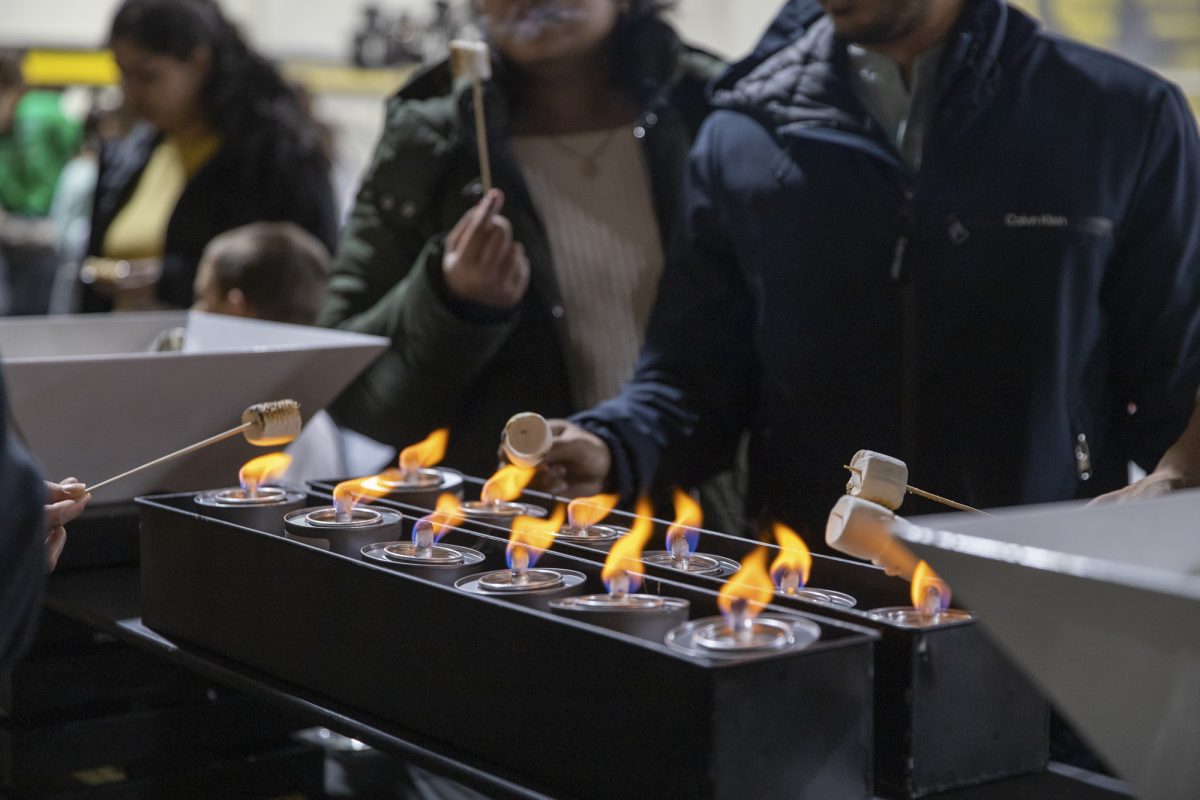 Wichita State students and community members make some smores in the Heskett Center during the Winter Welcome event in the Heskett Center.