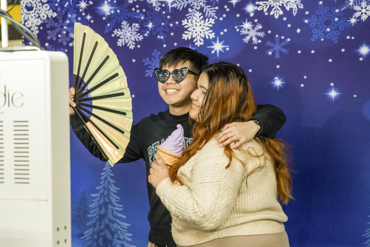 Two Wichita State students pose at the photo booth during the Winter Welcome in the Heskett Center. Students, faculty and staff participated in Winter Welcome on Friday, Jan. 19.