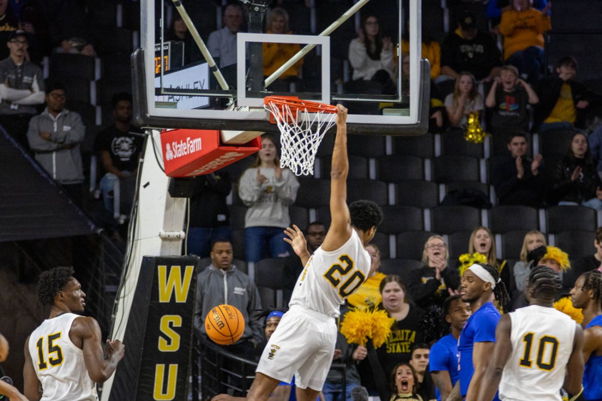 Redshirt junior guard Harlond Beverly hangs off the rim after scoring a point for Wichita State against Southern Methodist University on Jan. 28. He scored total of 14 points during his 35 minutes on the court.