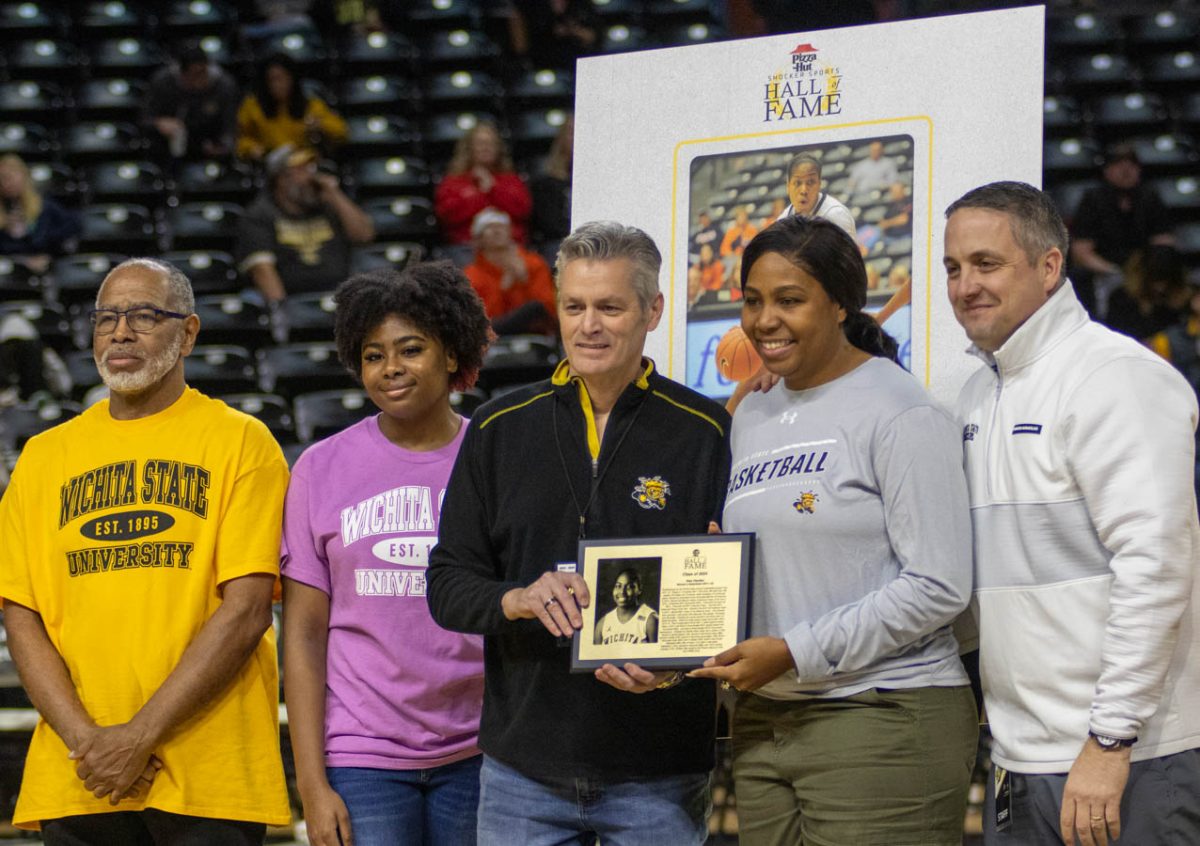 Wichita State President Richard Muma presents the Hall of Fame award during the Southern Methodist University basketball game on Jan. 28.