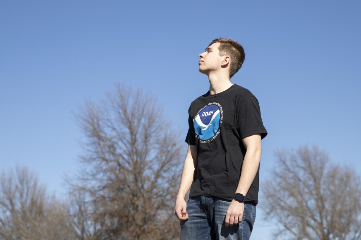 WSU+Storm+Trackers+founding+member+Tristan+Schwien+poses+for+a+photo+while+looking+at+the+sky.+Growing+up+in+Kansas%2C+Schwien+had+been+interested+in+meteorology+from+a+young+age.+He+started+the+group+to+build+a+community+with+other+students+interested+in+weather.