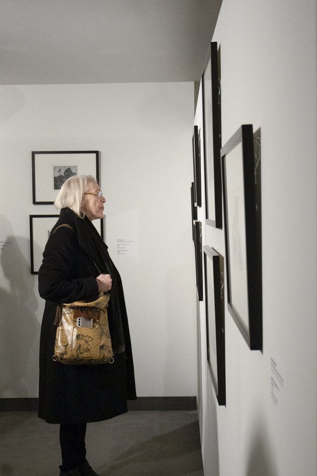 Assistant Dean of the College of Fine Arts Wendy Hanes views the gallery of Marco Hernandez titled Sin Perder A Mis Raíces (Without Losing My Roots) at the Wichita Art Museum on Jan. 19.