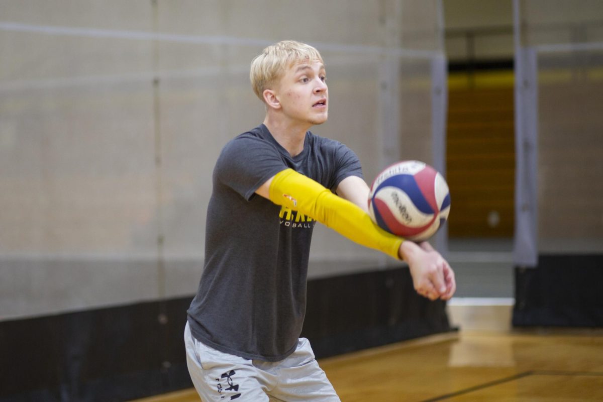 Noah Harlan, a member of the recreational mens volleyball team at Wichita State, volleys the ball during practice on Jan. 30.