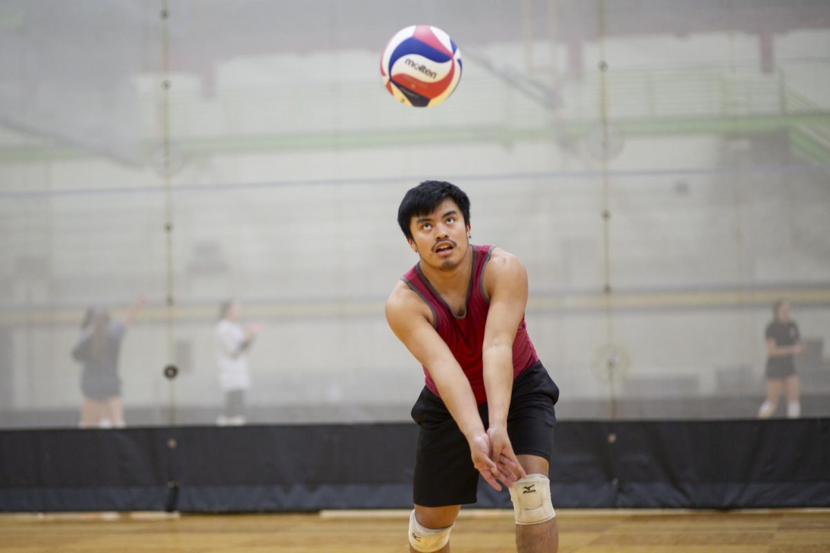 Ethan Leigh, a member of the recreational mens volleyball team at Wichita State, prepares to volley the ball during practice on Jan. 30.