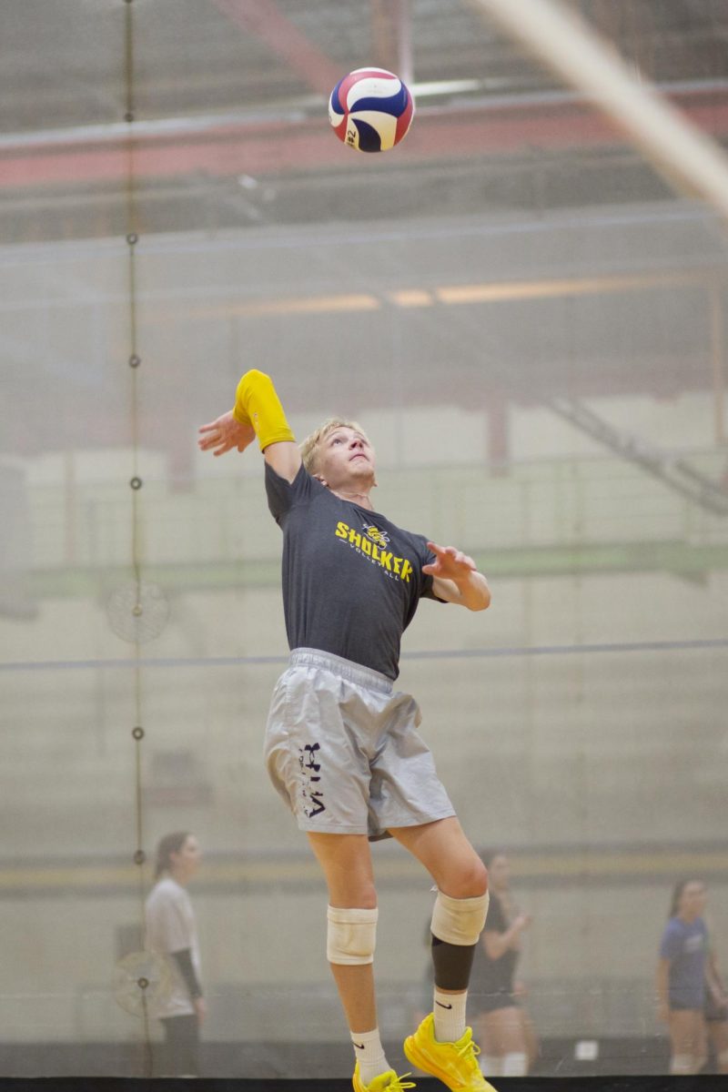 Noah Harlan, a member of the recreational mens volleyball team at Wichita State, gets ready to volley the ball during practice on Jan. 30.