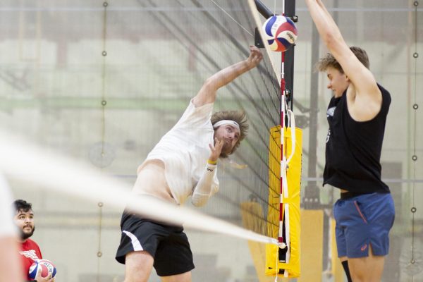 Evan Kruse attempts to send the ball past Zach Oakley during the recreational mens volleyball teams practice on Jan. 30.