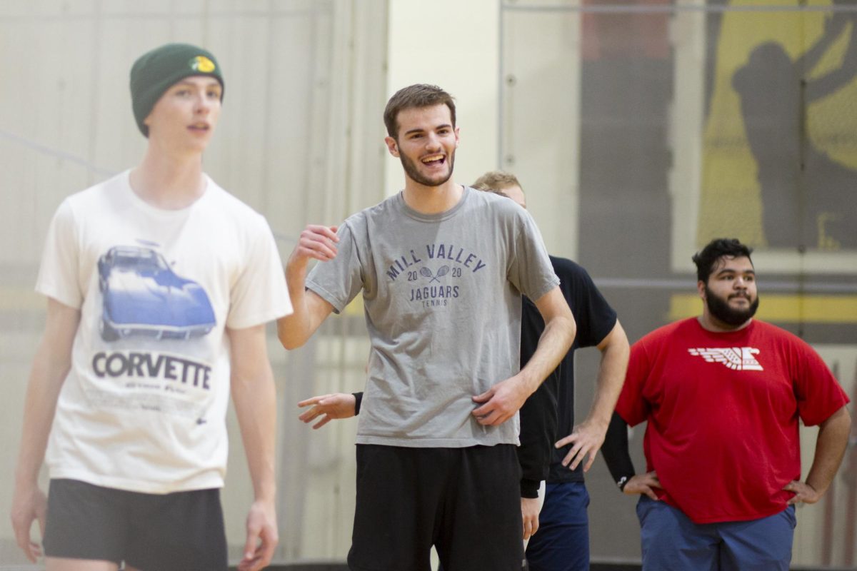 Xander Pickett, a member of the recreational mens volleyball team at Wichita State, cheers after a well-done move by a teammate. The team practiced inside the Heskett Center on Jan. 30.