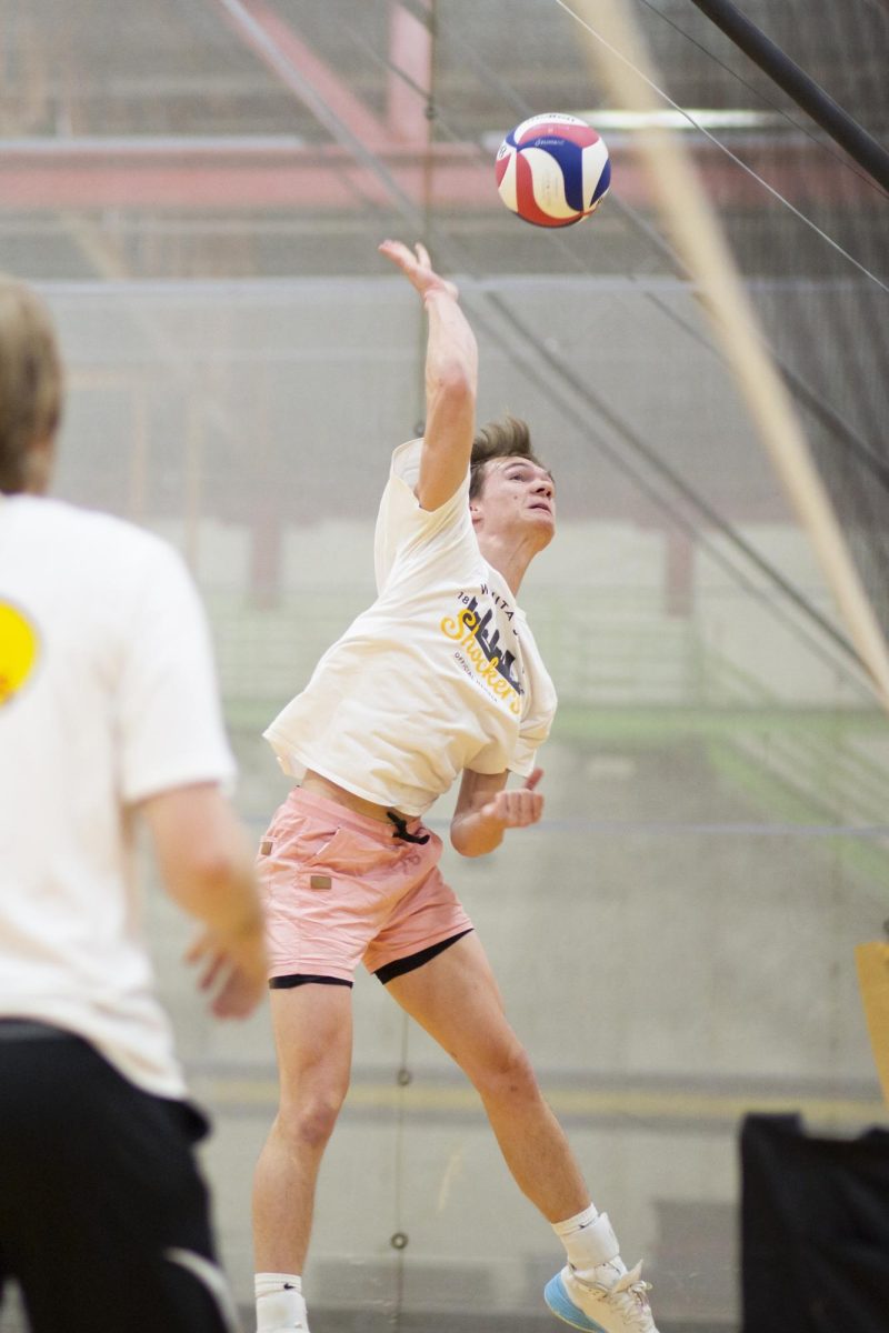 Owen Landis, a member of the recreational mens volleyball team at Wichita State, gets ready to hit the ball over the net during practice in the Heskett Center on Jan. 30.