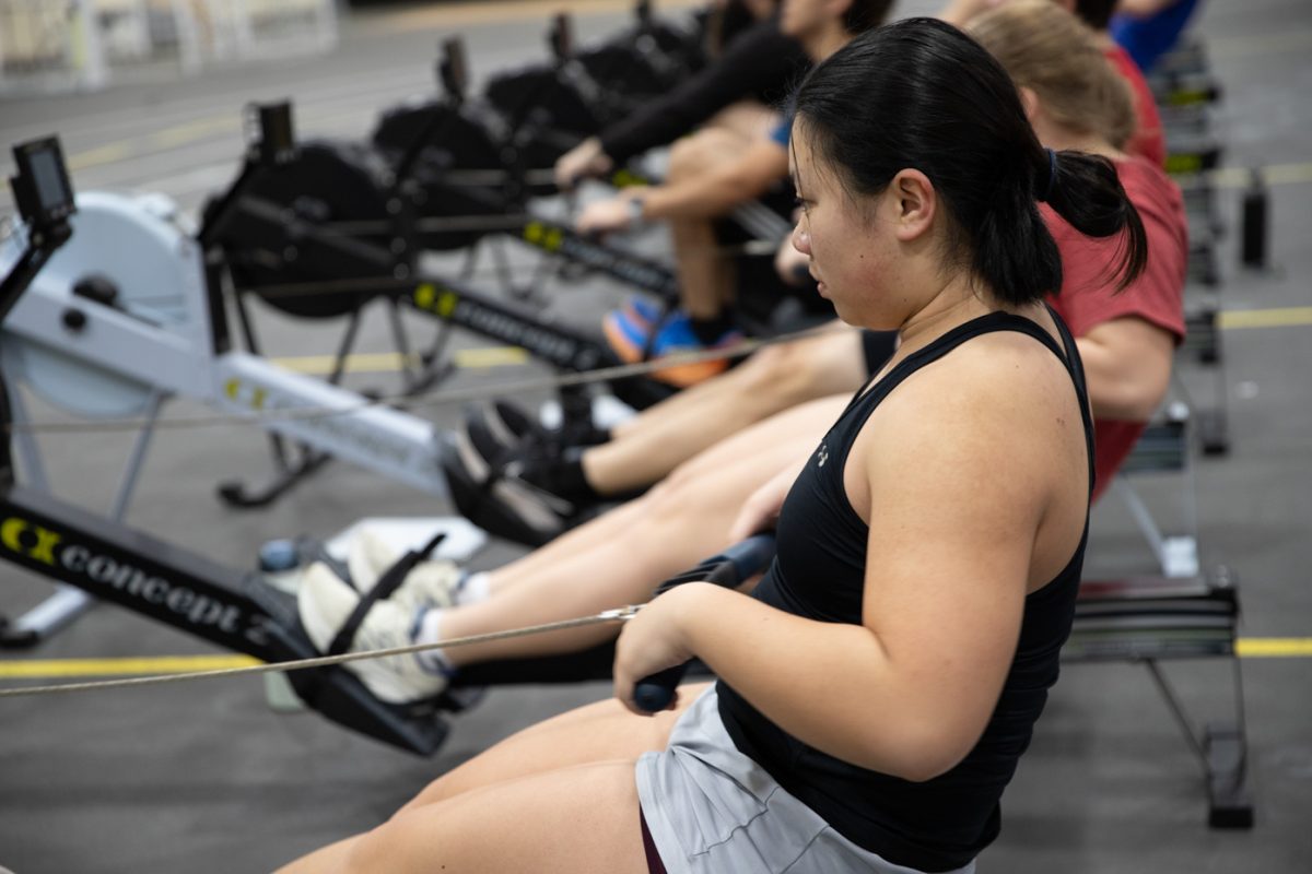 Biomedical engineering major Makenzie Amphone uses an ergometer machine with rowing teammates at practice. The Wichita State rowing team uses the ergometer machines on Tuesdays and Thursdays in the Heskett Center gymnasium in preparation for their spring season.