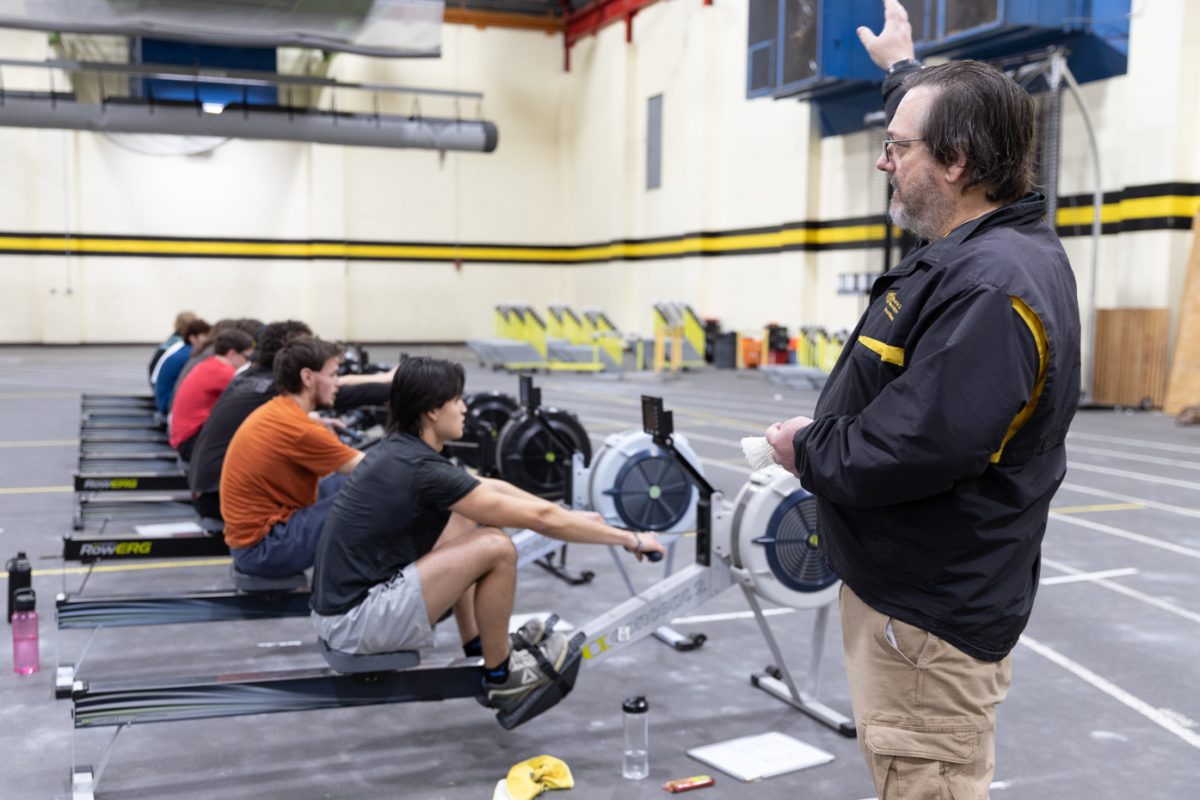 Wichita State rowing team coach Calvin Cupp instructs the team as they use the ergometer machine at practice. The rowing team practices on the ergometer machine on Tuesdays and Thursdays and does strength and conditioning the rest of the week.