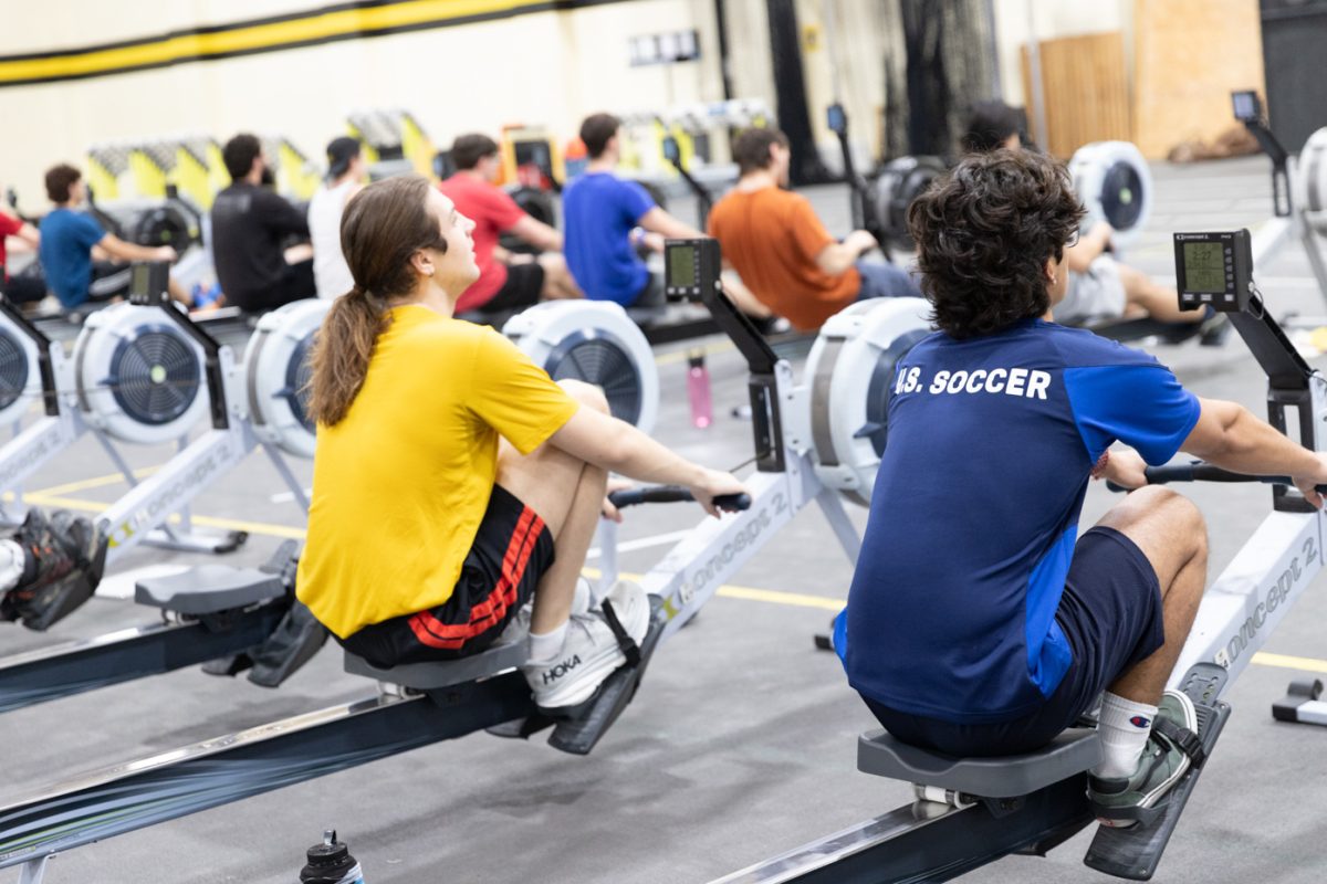 Tyler Troyer and Emilio Veana use ergometer machines during rowing team practice. The Wichita State practices on ergometer ,achines in preparation for their spring season in the Heskett Center gymnasium.