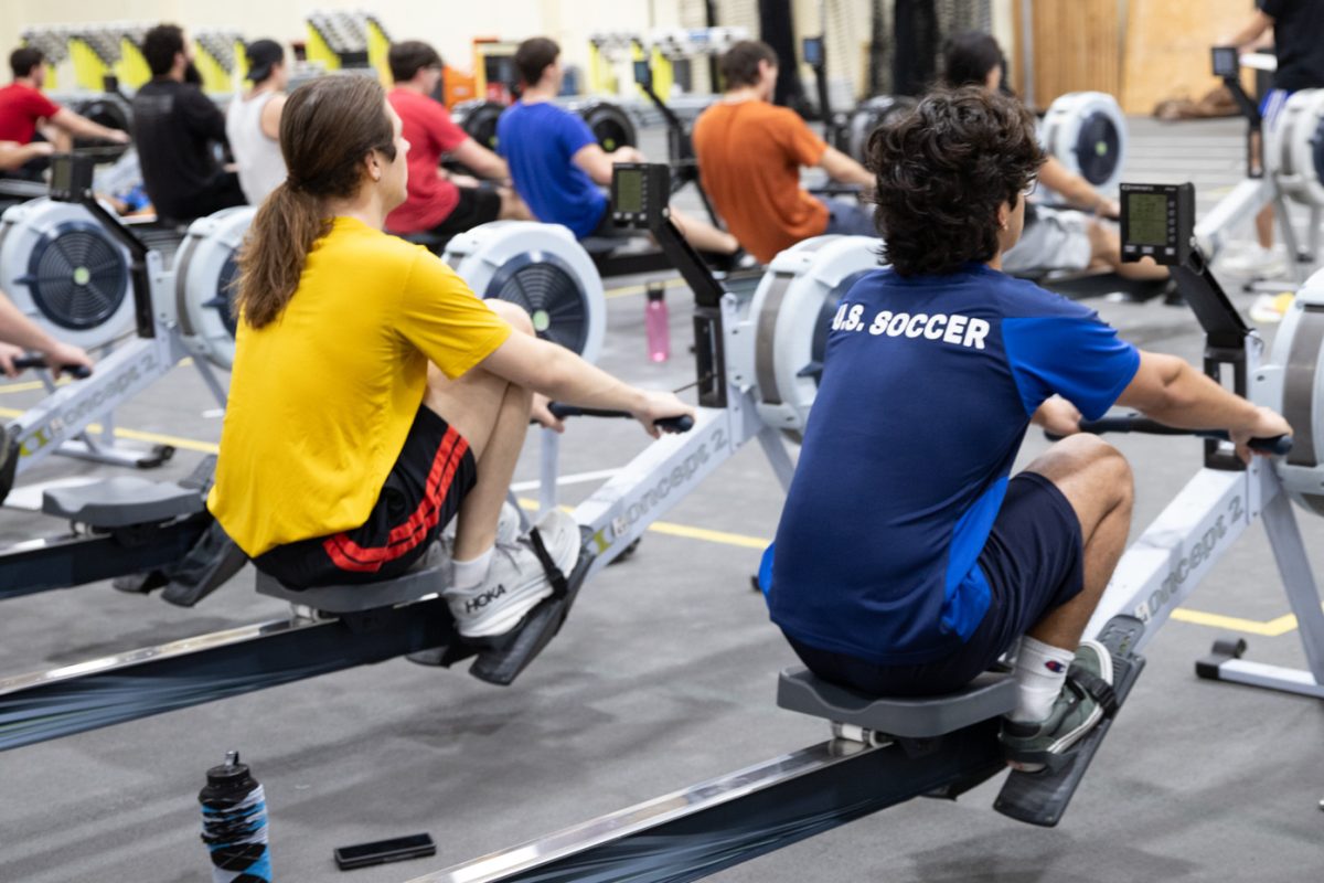 Tyler Troyer and Emilio Veana use ergometer machines during rowing team practice. The Wichita State practices on ergometer ,achines in preparation for their spring season in the Heskett Center gymnasium.