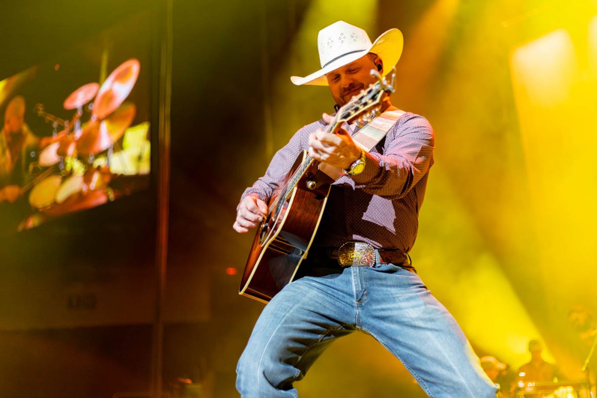 Cody Johnson plays his guitar during his opening song on Feb. 9. Johnson performed at Intrust Bank Arena as part of The Leather Tour.