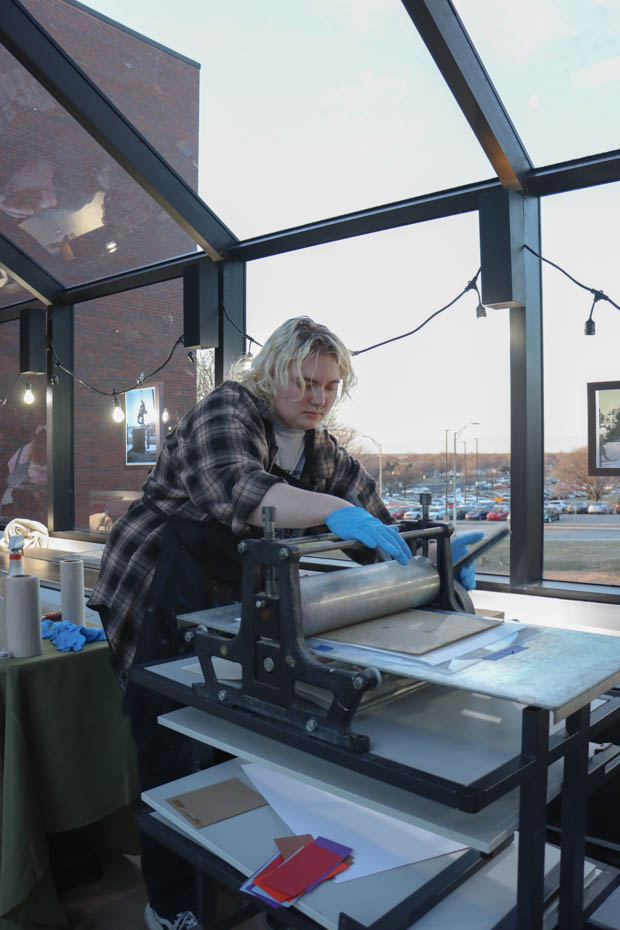 Niki Noland printing a drawing on Feb, 14 at the Museum Makers & Masterpeices event. The free event took place at the Ulrich Museum of Art and taught attendees the printmaking process. 