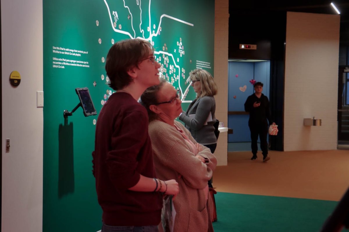Rebecca and Tabitha Gifford looking at the Your Thoughts and Ideas wall in the Ulrich Museum of Art. The wall allows for guests to write suggestions and feedback to the museum. 
