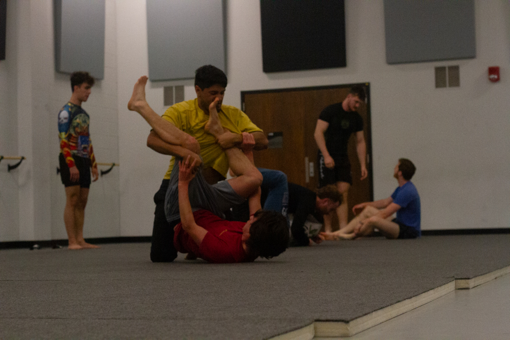Ethan Hill tries to turn his opponent over in a sparring match at the end of their Brazilian jiu-jitsu class.
