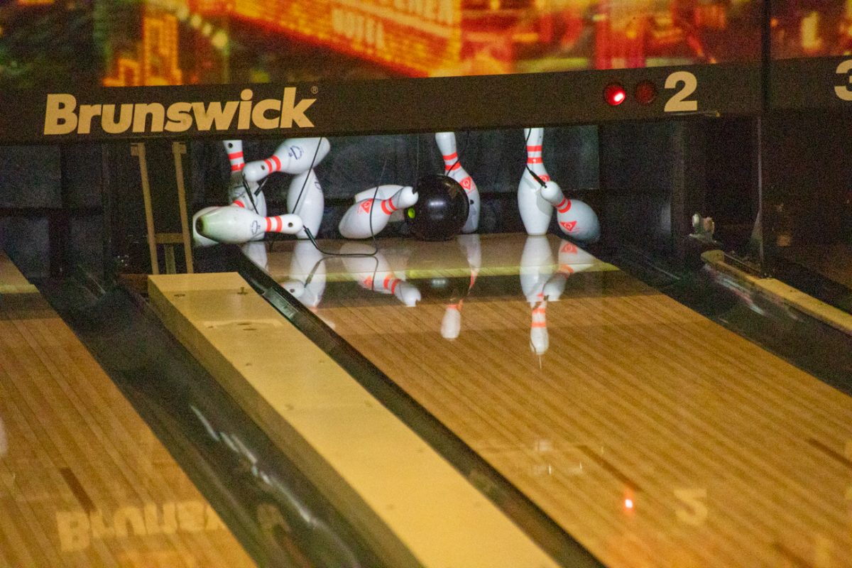 A bowling ball strikes pins during practice on Feb. 21.