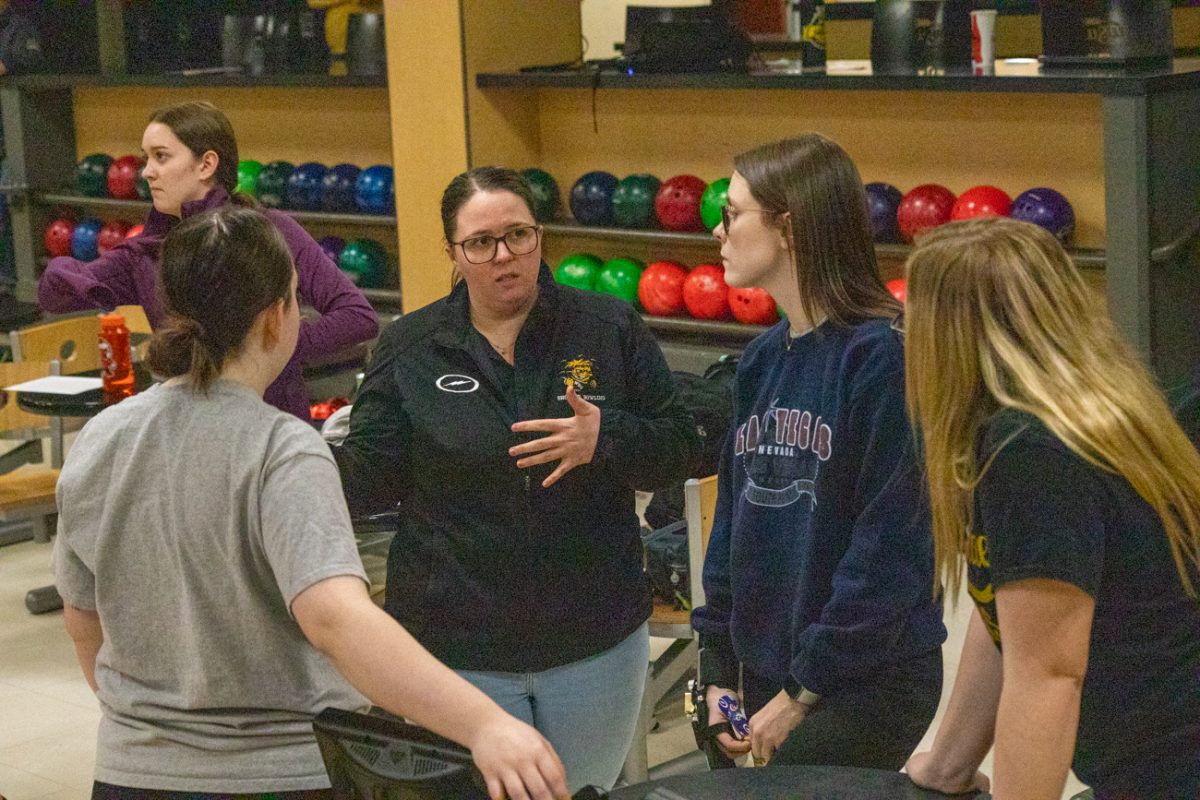 Womens bowling head coach Holly Harris talks to players during practice. Harris, a former player, has coached for the team for four years.