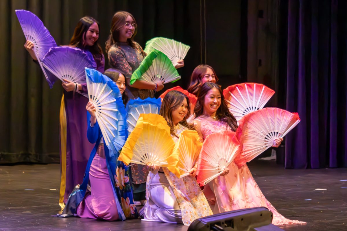 Members of the Vietnamese Student Association dance group end their dance by showcasing fans at the annual VSA Tet Show on Feb. 24.