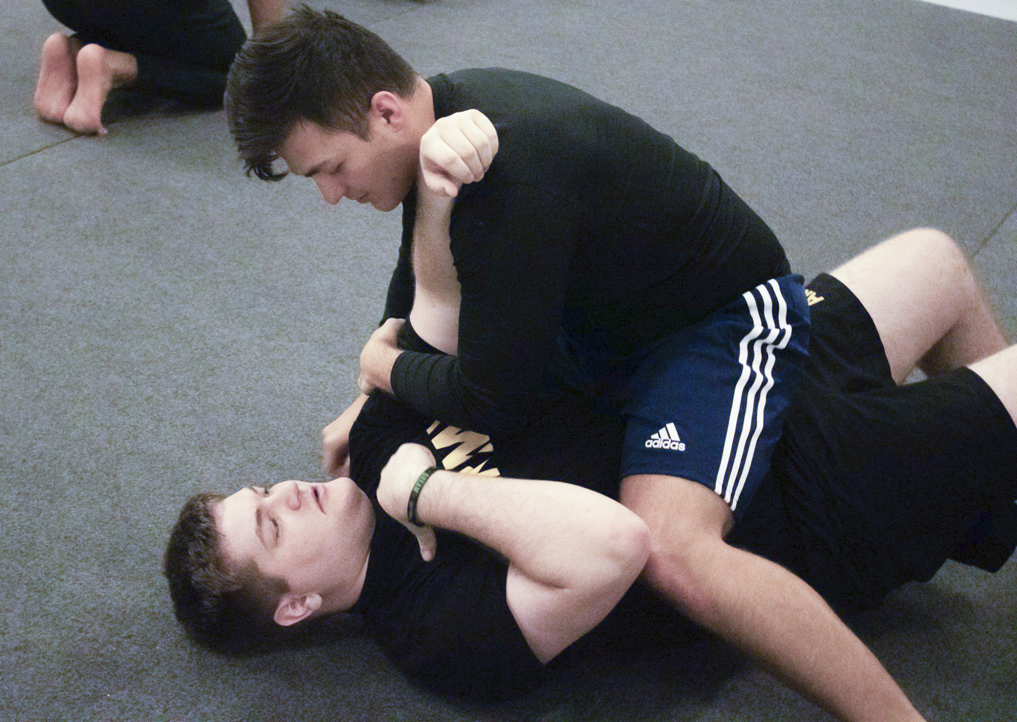 A couple of Wichita Statestudents practice  a Brazilian jiu-jitsu technique.