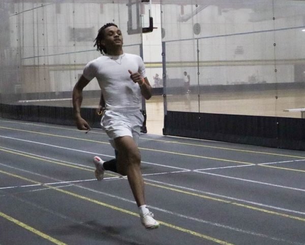Freshman sprinter, jumper and hurdler Josh Parrish practices his sprints during track and field practice inside the Heskett Center. Parrish and his twin brother, Jason, both compete for Wichita State.