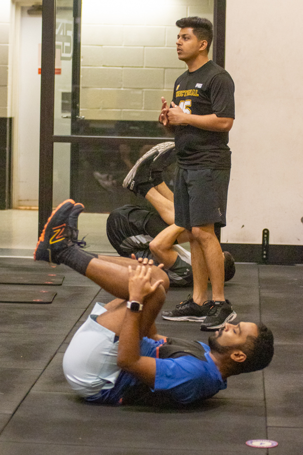 Prabal Neema, a graduate student at Wichita State, encourages F45 participant Lokeshreddy Lingareddy. Neema has been a F45 instructor for two semesters.