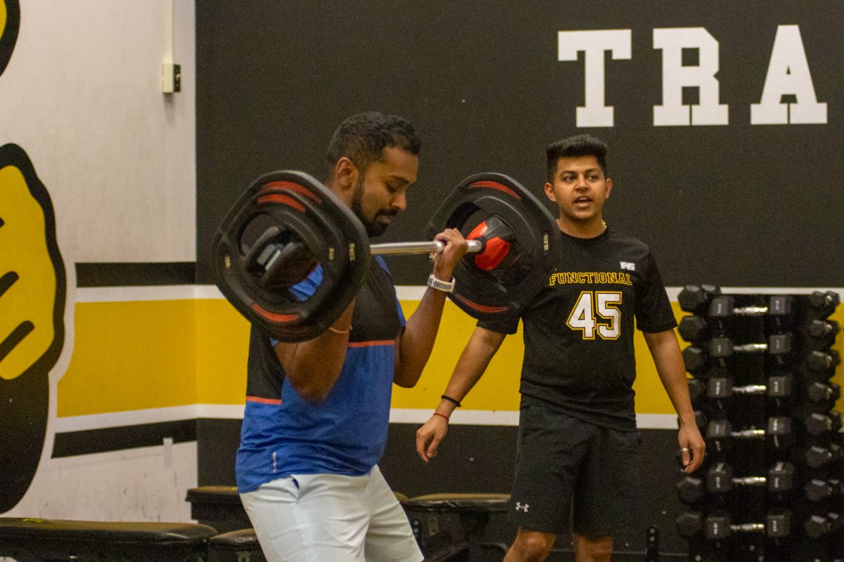 Prabal Neema (left), a graduate student at Wichita State, encourages F45 participant, Lokeshreddy Lingareddy. Neema has been a F45 instructor for two semesters.