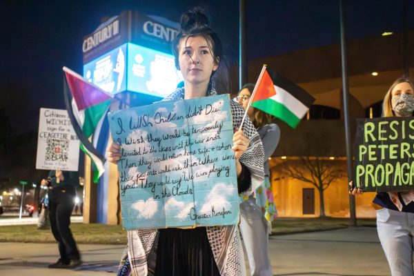 A protestor displays a sign with a quote by Palestinian author and politician Ghassan Kanafani. I would love to go to Gaza and help those children that youre starving, she said in response to a heckler.