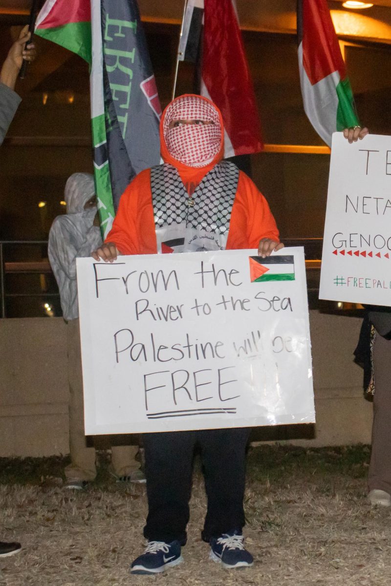 11-year-old Ifram holds a sign while protesting with his family at Century II Convention Center. “People are dying in Palestine. I want to make them stop, Ifram said.