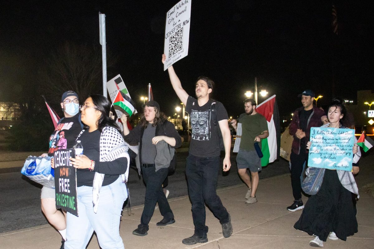 Wichita State students and community members march outside of Century II during Jordan Petersons We Who Wrestle with God event. Protesters recited chants like 1-2-3-4, occupation no more, 5-6-7-8, Israel is a terror state.