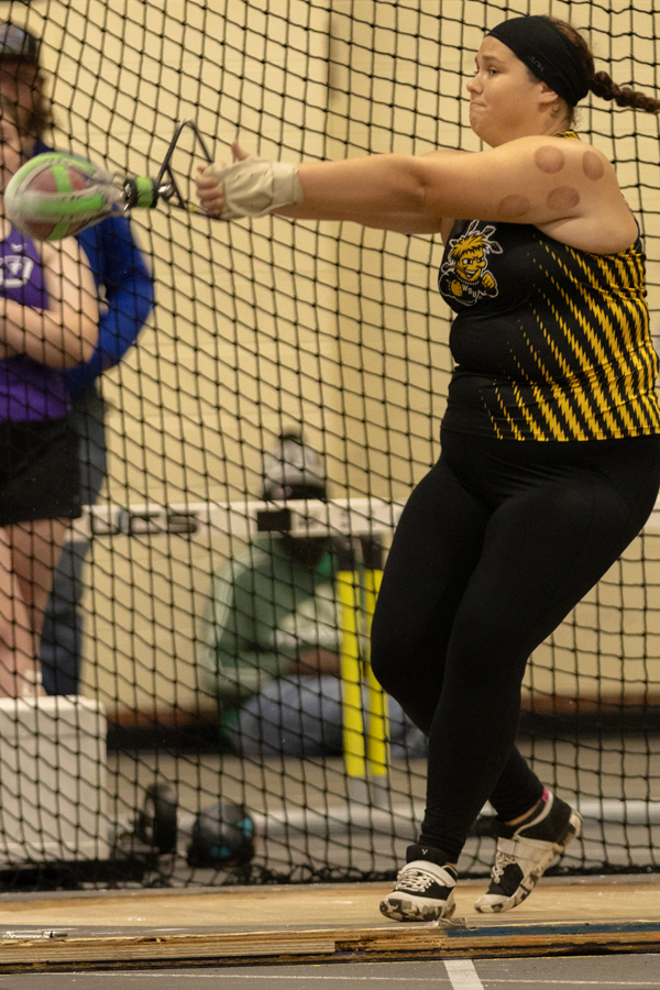 Junior Kylie Zimmer participates in the weight throw on Jan. 26 at the Wilson Invitational. Zimmer placed seventh in the competition with a throw of 489.