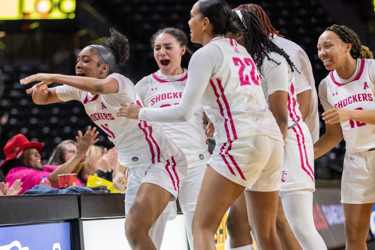 Followed by her teammates, freshman Salese Blow slams her hands on the table after making a 3-point buzzer shot to send the Shockers into overtime against SMU.